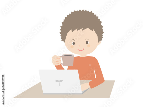 Young man drinking coffee while looking at a laptop.