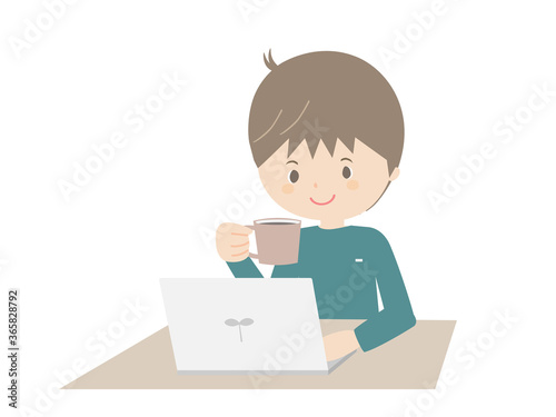 Young man drinking coffee while looking at a laptop.