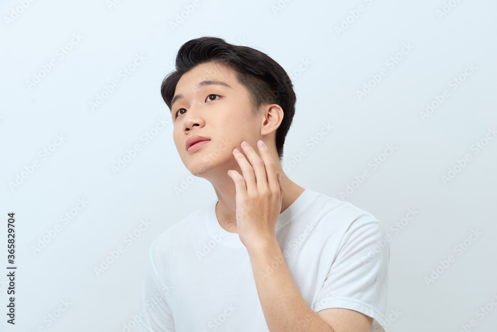 Young handsome man checking his face skin Young handsome man checking his face skin
