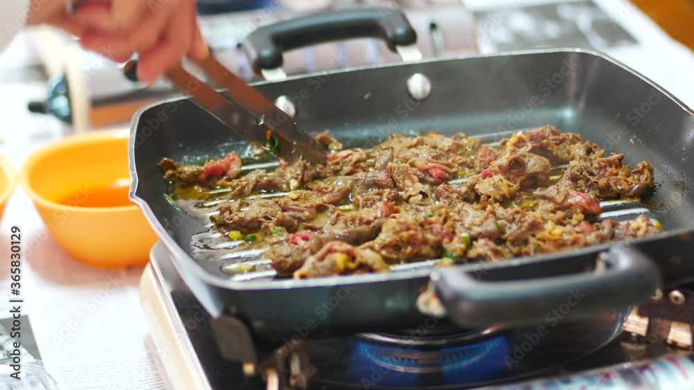 Person take cooking of meat with vegetable grill at home during pandemi. Family concept.