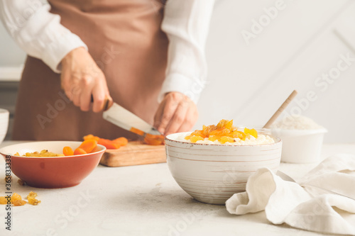 Woman preparing tasty rice in kitchen, closeup