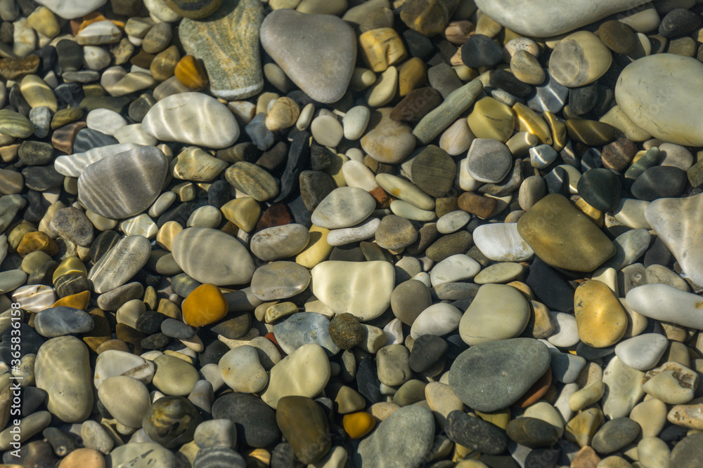 Sea stones and rocks of different sizes and texture of black, gray and brown under the water on the Black Sea coast as nature background. Excellent concept for any design Sea stones and rocks of different sizes and texture of black, gray and brown under the water on the Black Sea coast as nature background. Excellent concept for any design