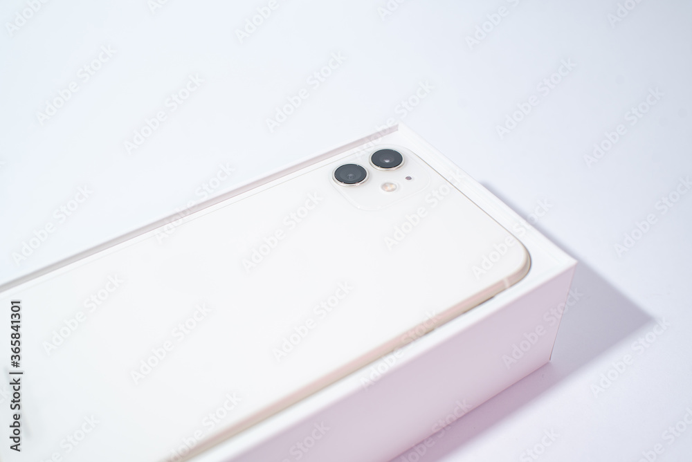 White smartphone with two cameras on a white background