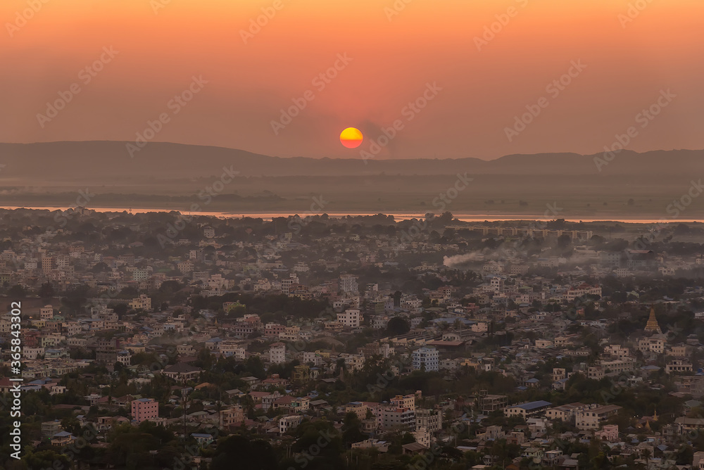 Sunset over Irrawaddy river and Mandalay city, Myanmar. Mandalay is the second-largest city in Myanmar, after Yangon, and is located on the east bank of the Irrawaddy River