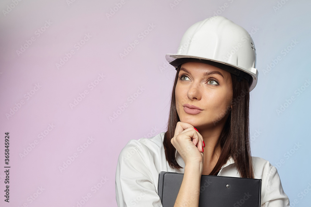 the girl in the white helmet points the direction with her hand. the concept of a businesswoman who understands construction, repair and modernization.. the girl in the white helmet points the direction with her hand. the concept of a businesswoman who understands construction, repair and modernization..