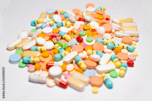 Colorful drugs, vitamins and medicine - capsules, tablets, pills - against white background