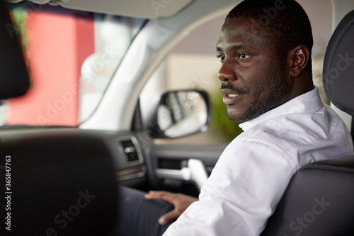 young african couple sit inside of car and discuss it before purchase, black man have conversation with wife © alfa27