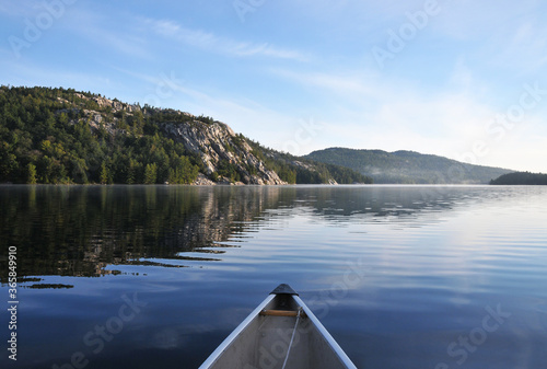canoe and rocky shoreline of George Lake and La Cloche mountains Killarney Park Ontario Canada