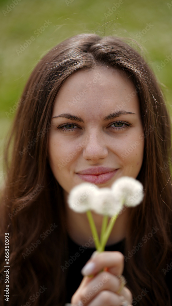 Pretty girl with three dandelion in a flowering field Pretty girl with three dandelion in a flowering field