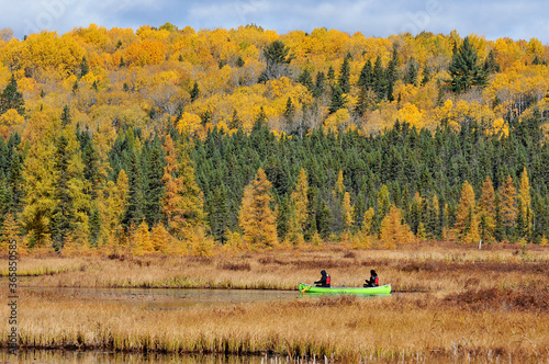 canoe on river in autumn color Algonquin Park Ontario Canada photo