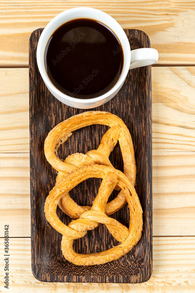 pretzels on wood table and black coffee pretzels on wood table and black coffee