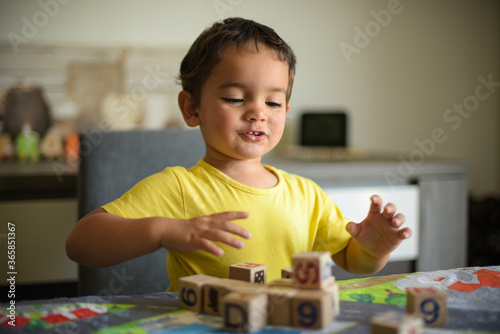 young child playing with cubes