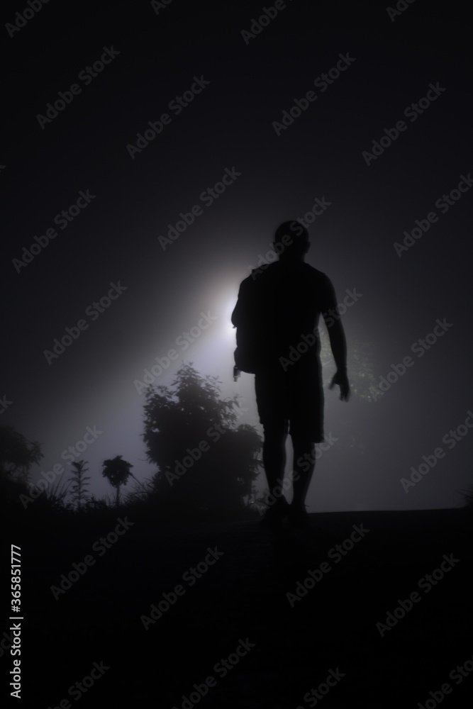 silhouette of a man walking in the night silhouette of a man walking in the night