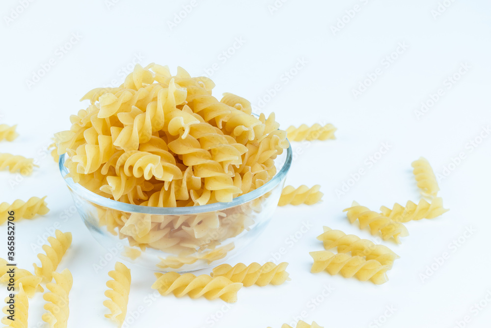 Raw pasta in a cup is isolated. Raw pasta in a cup is isolated.