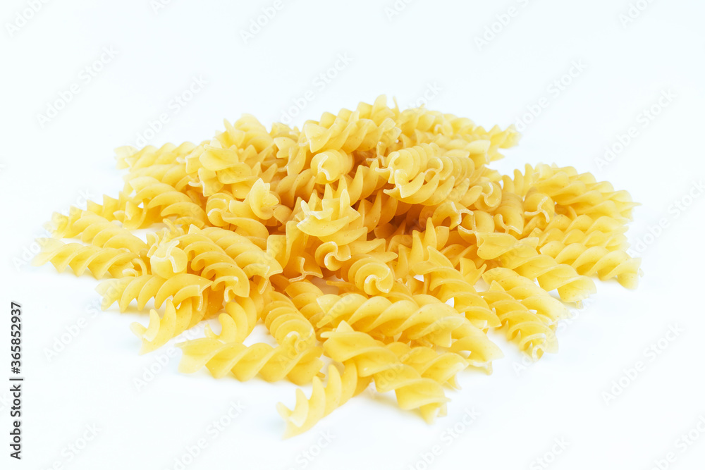 Raw pasta on a white background.