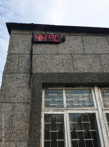 Concept on the topic of abnormal hot summer. Digital display thermometer which shows 44 degrees Celsius .Vertical photo