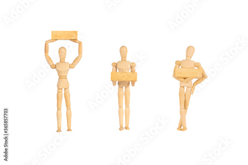 Wooden manikins human model standind and gesturing and holding wooden block isolated on white background.