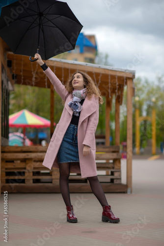 Portrait of a girl with an umbrella in the park.