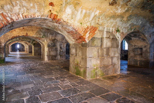 Abandoned fort with many arches and stone floor
