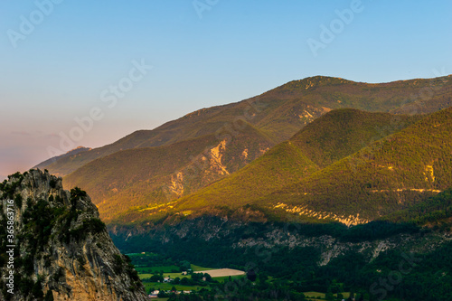 A picturesque landscape view of the Alps mountains and the valley of river Var during sunset (Puget-Theniers, Alpes-Maritimes, France)