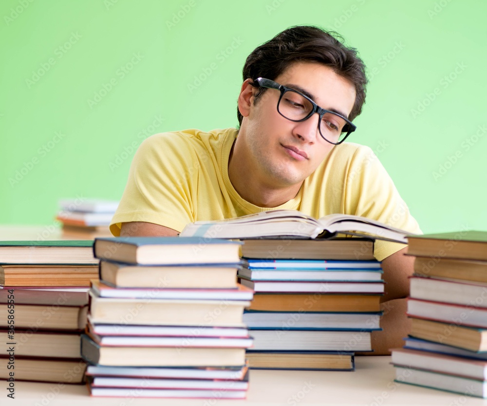 Student with too many books to read before exam Student with too many books to read before exam