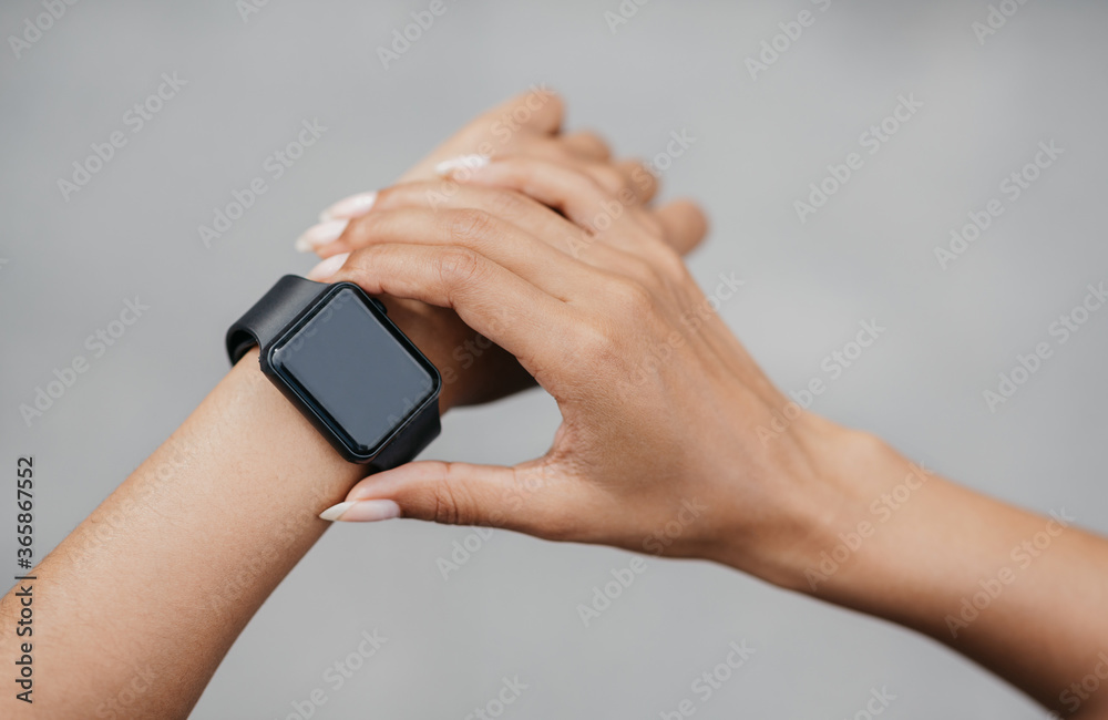 Check activity of body. African american girl check smart watch with blank screen Check activity of body. African american girl check smart watch with blank screen