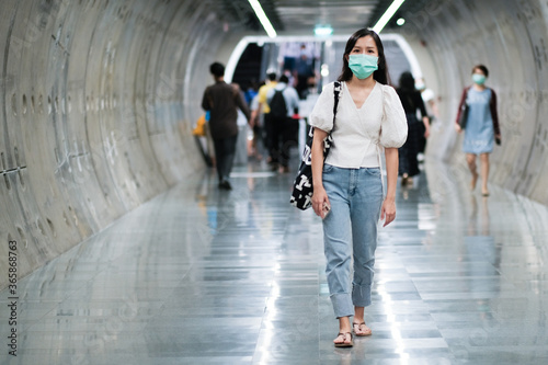 Asian girl wear surgical mask to protect the Covid-19 virus in public areas, New normal lifestyle
