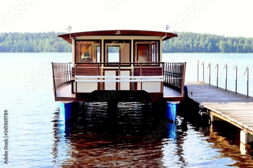 A double-hull pleasure boat stands at the pier awaiting tourists photo