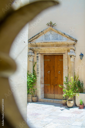 Nazareth, Israel. July 10, 2020: Synagogue Church in Nazareth through the grille of the gate. here Jesus delivered his famous sermon, in which he declared himself the Messiah