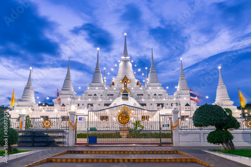 White Buddhist Pagoda with multiple spires at Wat Asokaram Temple in Samutprakan province, Thailand. photo