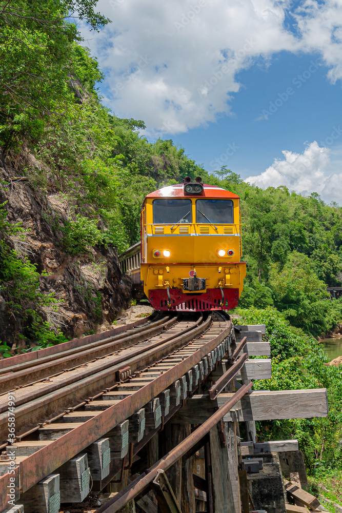 Fototapeta premium trains running on death railways track crossing kwai river in kanchanaburi thailand this railways important destination of world war II history builted by soldier prisoners
