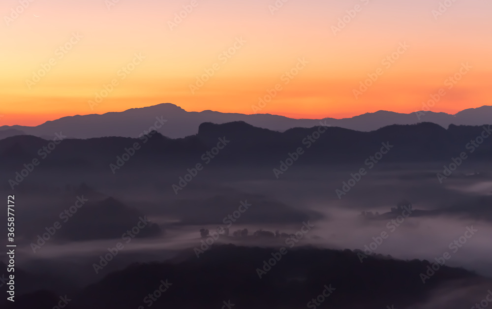 Landscape images of the complex mountains Floated out of the mist in the morning while the sun began to rise from the horizon, beautiful nature background to travel concept. Landscape images of the complex mountains Floated out of the mist in the morning while the sun began to rise from the horizon, beautiful nature background to travel concept.