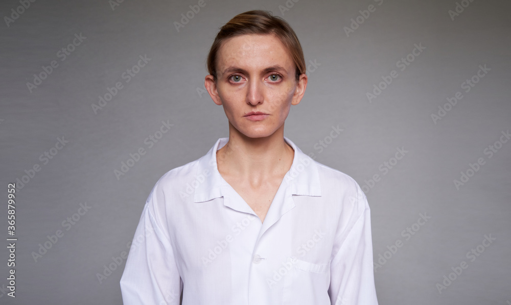 Close up female doctor or scientist over grey background Close up female doctor or scientist over grey background