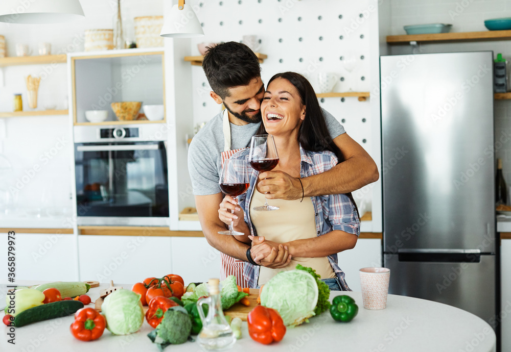 young couple kitchen home cooking love happy together preparationwine glass drinking food