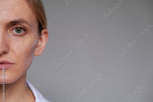 Close up female doctor or scientist over grey background