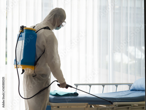 Man in Hazmat protective suits disinfecting in the hospital room during outbreak of Coronavirus, Covid-19.