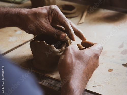 Ceramic molding, pottery dough making using wet soil. Worker molding clay to make pottery. Handmade earthenware.