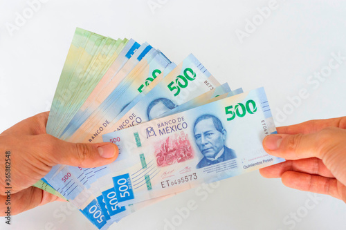 Hand taking money mexican pesos 