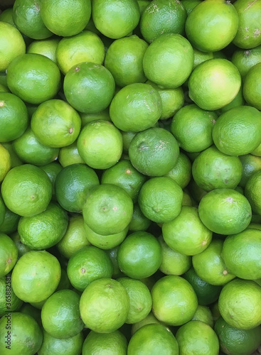 Fresh organic limes at a farm market stand displayed for sale 