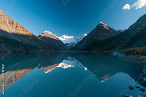 mountains with peaks in the snow and a close-up lake horizontally © dimm86