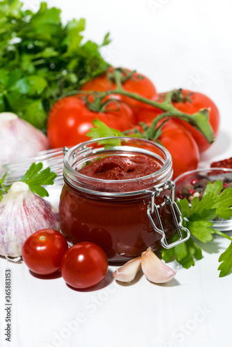 fresh tomato sauce and ingredients on white background, vertical