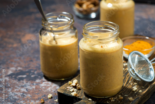 healthy carrot smoothies with turmeric and nuts, closeup