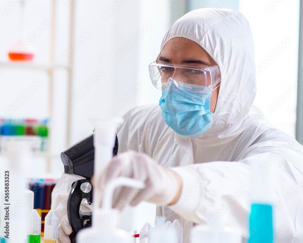 Young chemist student working in lab on chemicals Young chemist student working in lab on chemicals