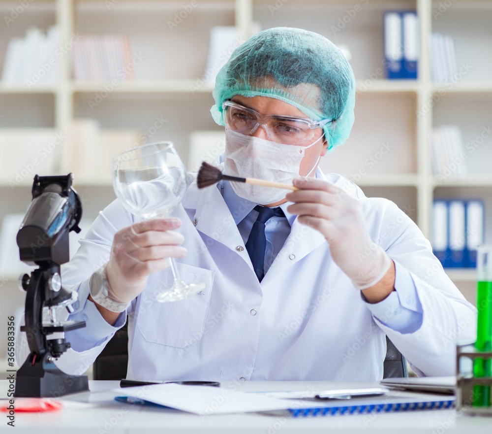 Forensics investigator working in lab on crime evidence Forensics investigator working in lab on crime evidence