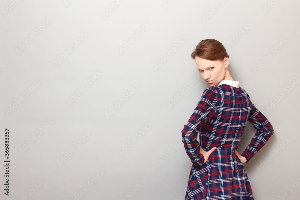 Portrait of angry disgruntled girl holding arms on hips Portrait of angry disgruntled girl holding arms on hips