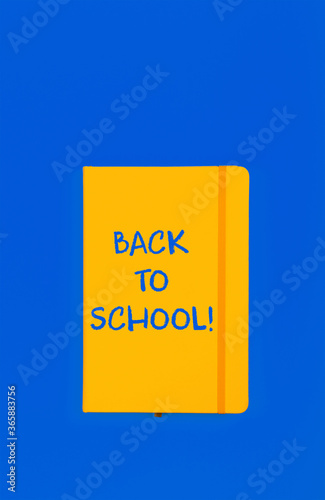 Back to school sign on yellow notebook