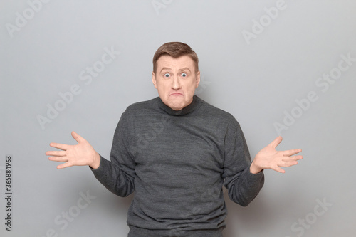 Portrait of angry disgruntled mature man wearing casual jumper