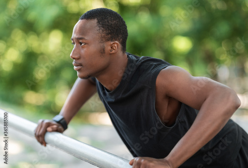 Concentrated african sportsman training his body at park © Prostock-studio