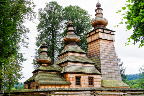 KWIATON, POLAND - AUGUST 12, 2017: Beautiful ancient wooden greek catholic church listed on UNESCO in Beskid Niski mountain range, Poland photo