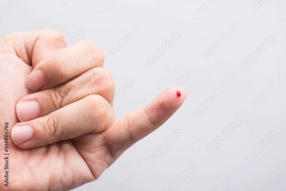Blood drop on fingertip prepare for checking the glucose level with a glucometer for examining diabetes mellitus. Blood drop on fingertip prepare for checking the glucose level with a glucometer for examining diabetes mellitus.